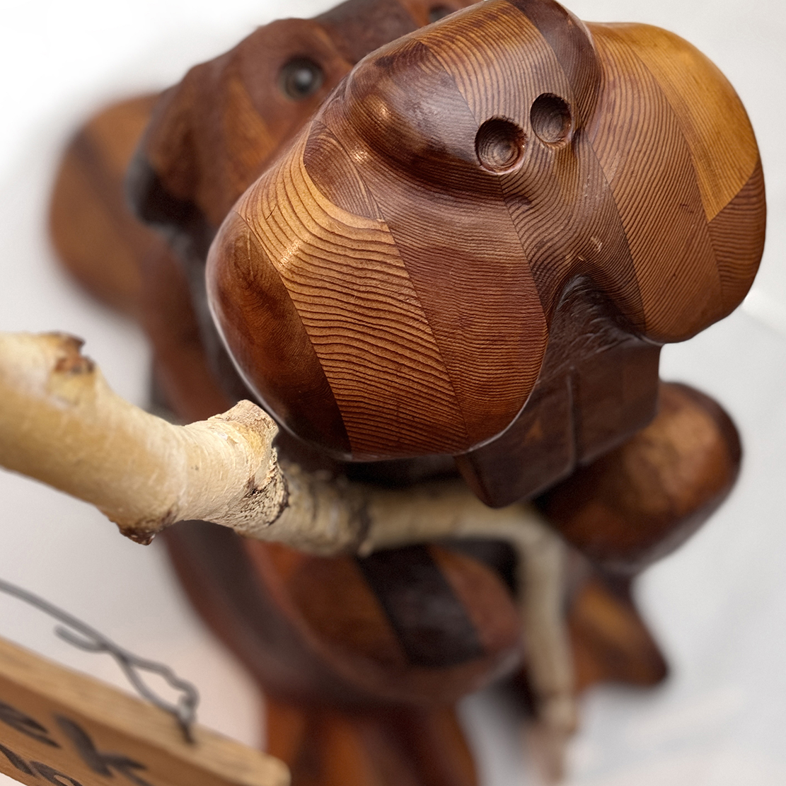 standing beaver holding a foggy creek carving sign